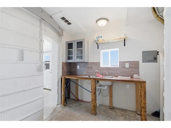 a kitchen with a sink and a refrigerator