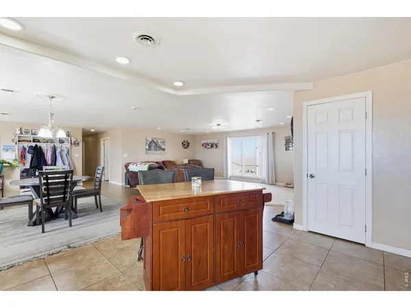 a kitchen that has a lot of cabinets a sink and a wooden floor in it