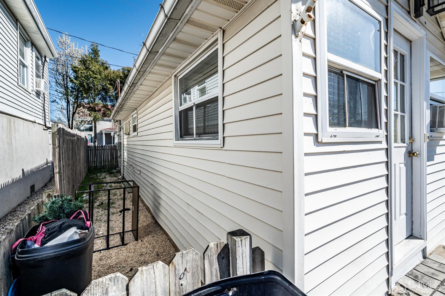 2 Neptune Place Keansburg, NJ 07734 - Photo 3 of 6 a view of a patio with couches chairs potted plants and floor to ceiling window