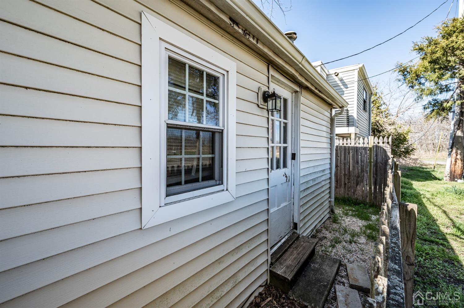 2 Neptune Place Keansburg, NJ 07734 - Photo 5 of 6 a view of a house with a large window and wooden fence
