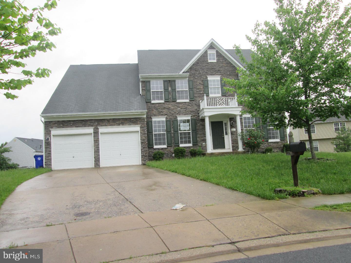 601 Crossover Court Frederick, MD 21703 - Photo 1 of 17 a front view of a house with a garden and trees