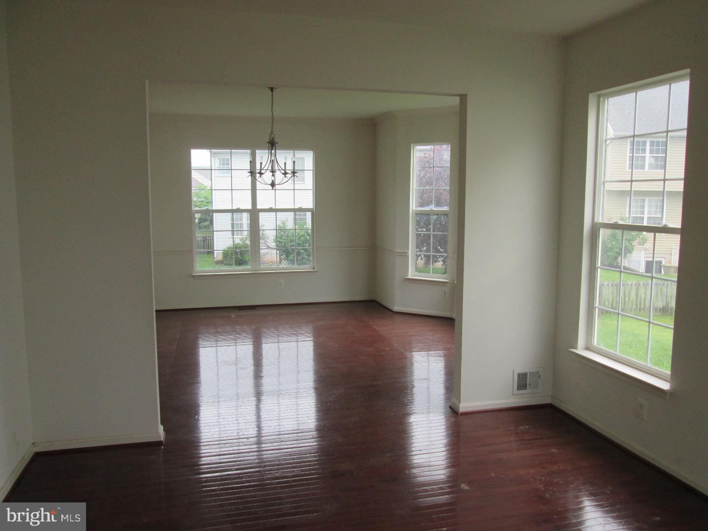 601 Crossover Court Frederick, MD 21703 - Photo 11 of 17 a view of an empty room with wooden floor and a window