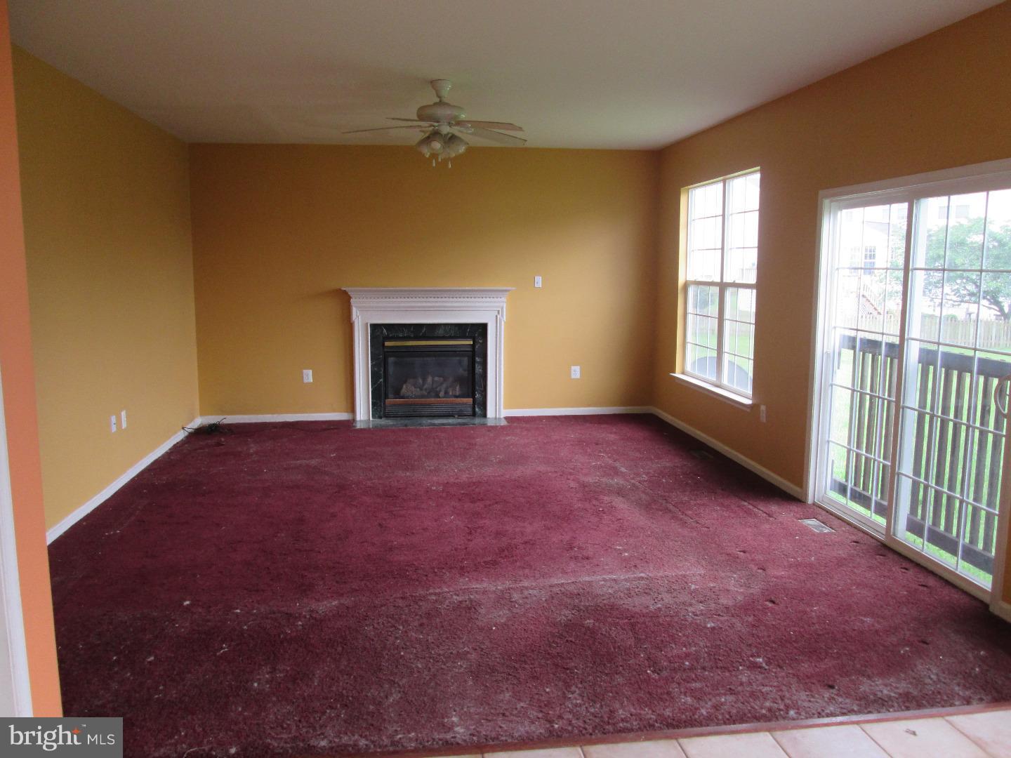 601 Crossover Court Frederick, MD 21703 - Photo 12 of 17 an empty room with a fireplace and windows