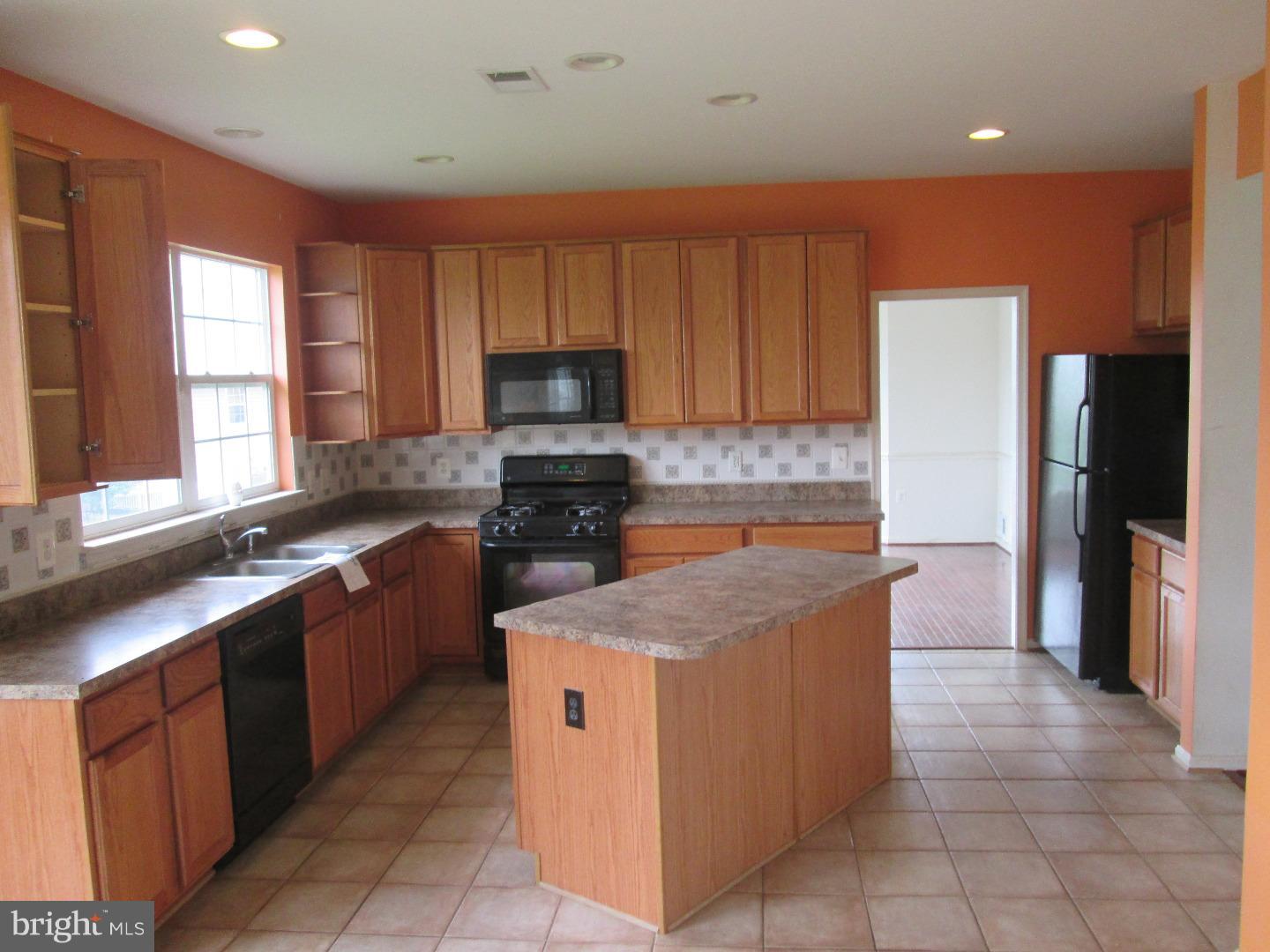 601 Crossover Court Frederick, MD 21703 - Photo 13 of 17 a kitchen with stainless steel appliances granite countertop a stove a sink and a refrigerator