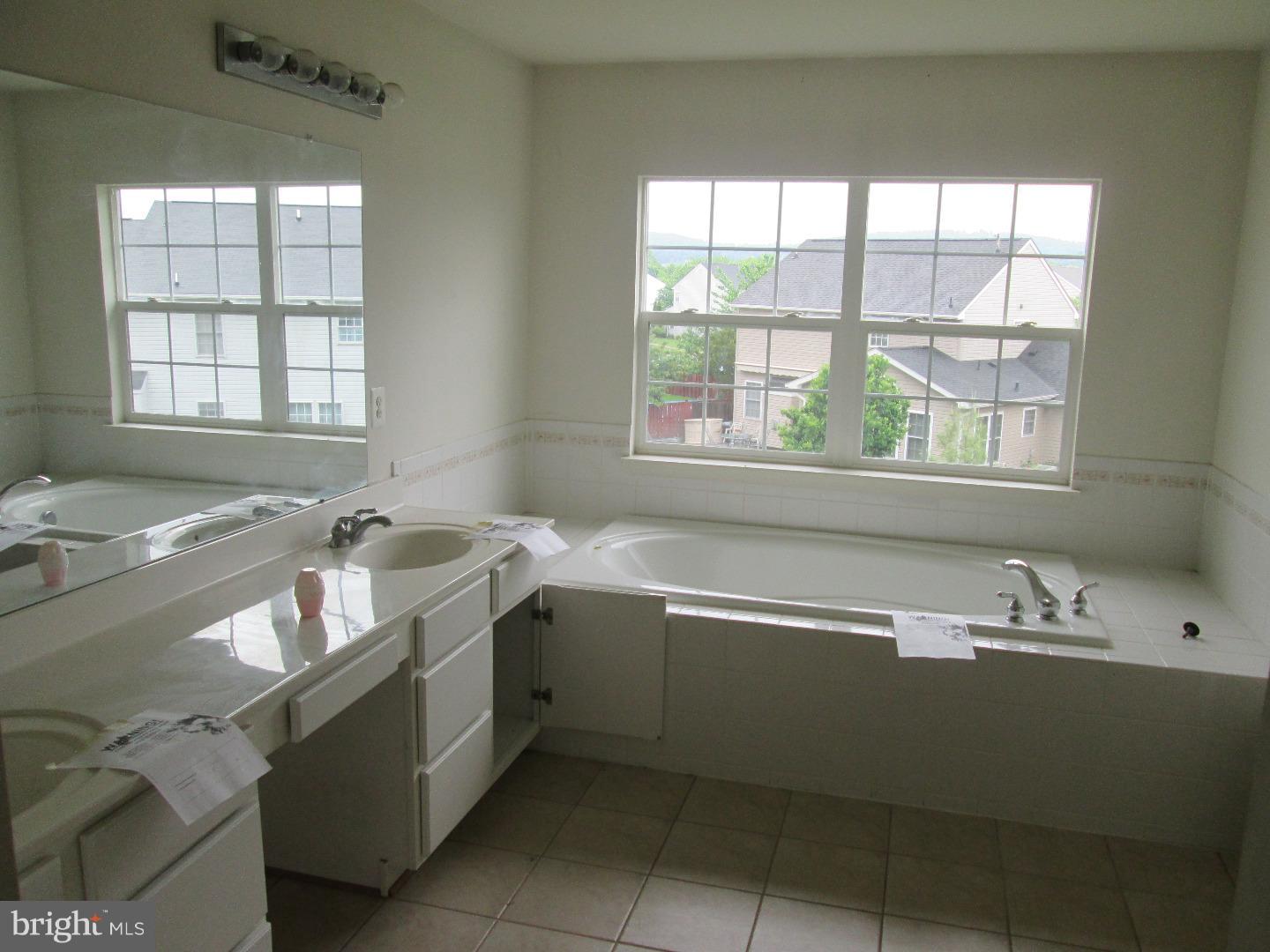 601 Crossover Court Frederick, MD 21703 - Photo 10 of 17 a bathroom with a tub sink and mirror