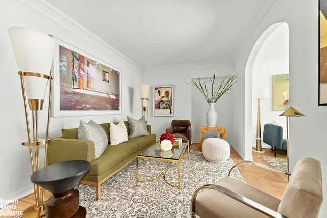 a living room with furniture or couch and a potted plant