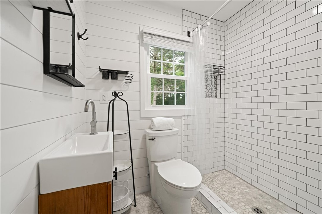 174 Holliday Road Six Mile, SC 29682 - Photo 30 of 49 White shiplap walls and subway tile create a clean, contemporary aesthetic in this well-appointed bathroom