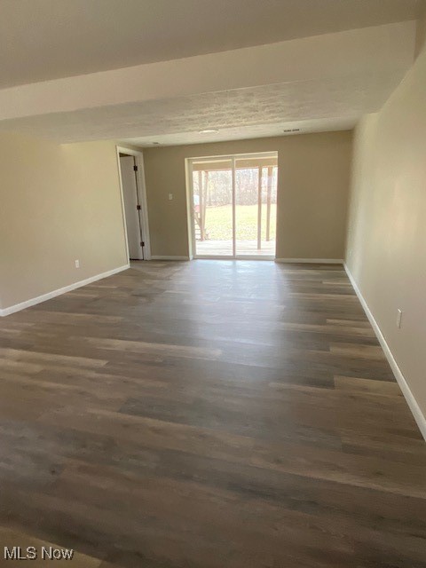 2868 Pressler Road Uniontown, OH 44685 - Photo 29 of 37 Unfurnished room with baseboards and dark wood-type flooring