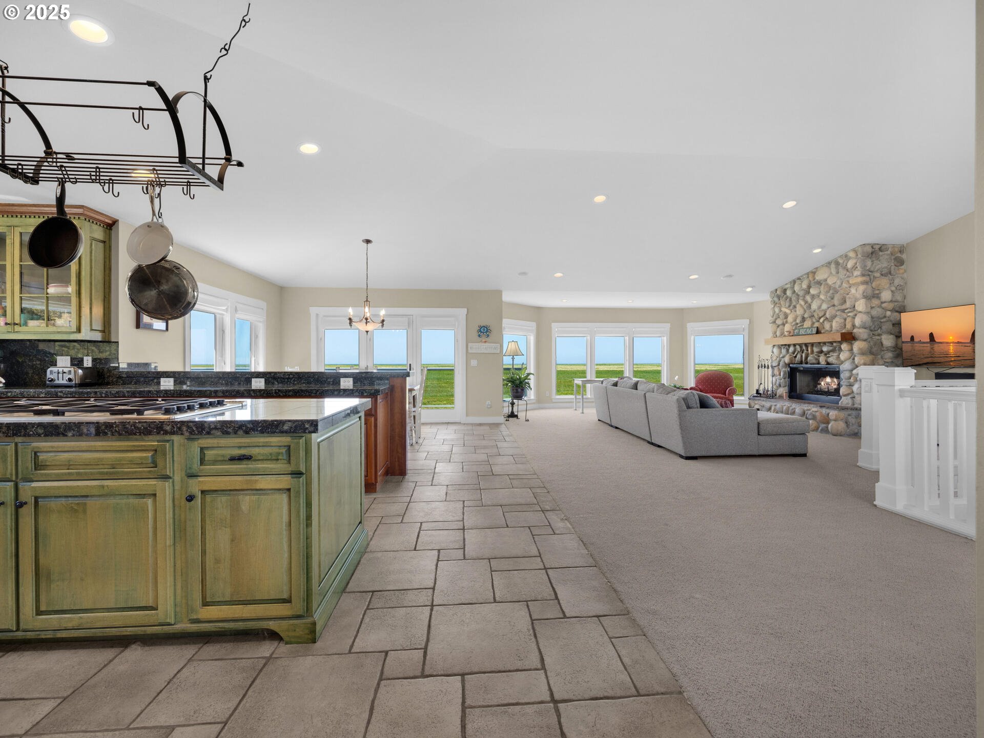 89185 Pinehurst Road Seaside, OR 97138 - Photo 11 of 48 a large kitchen with cabinets and a wooden floor