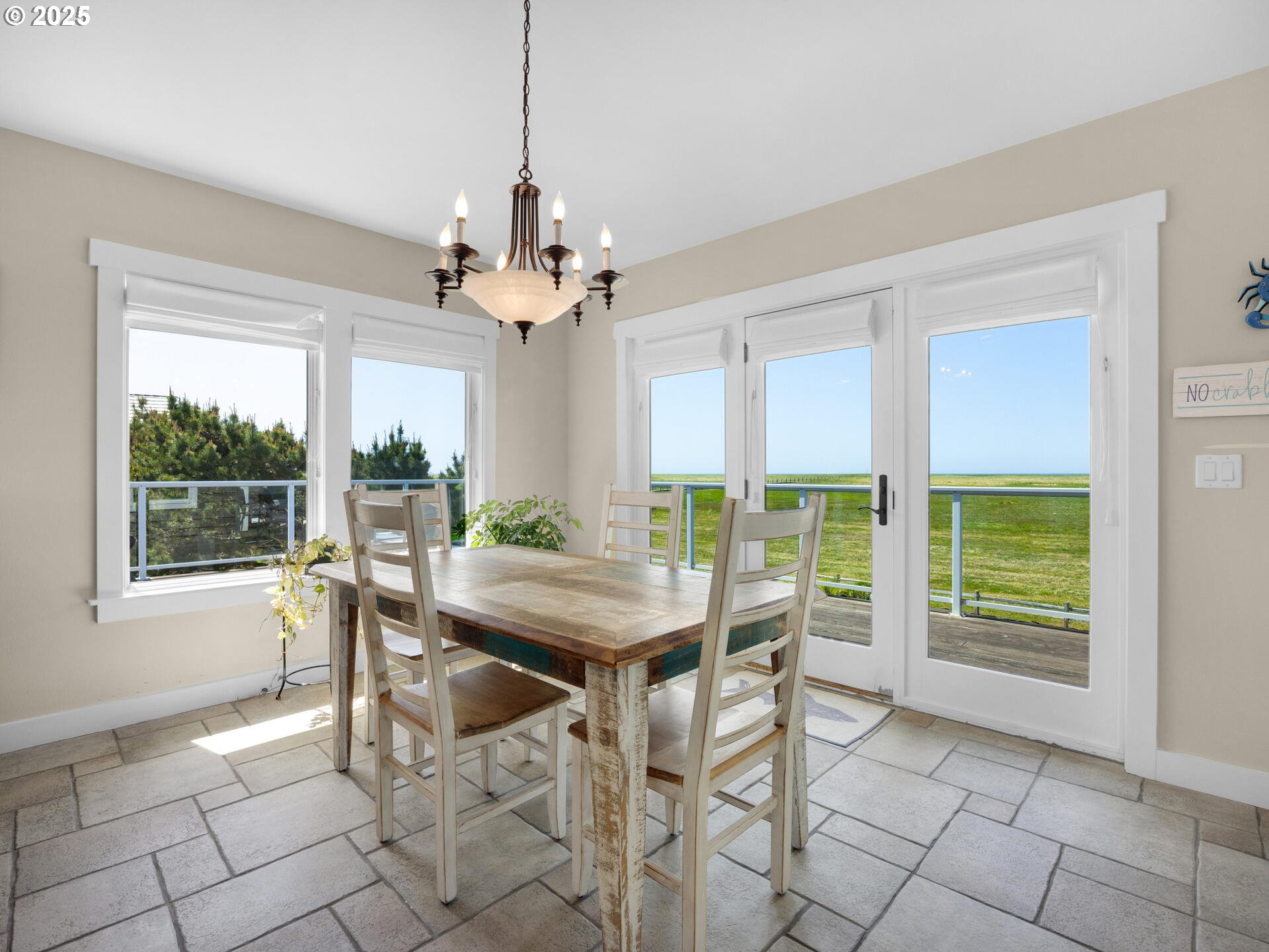 89185 Pinehurst Road Seaside, OR 97138 - Photo 12 of 48 a dining room with furniture a chandelier and a rug