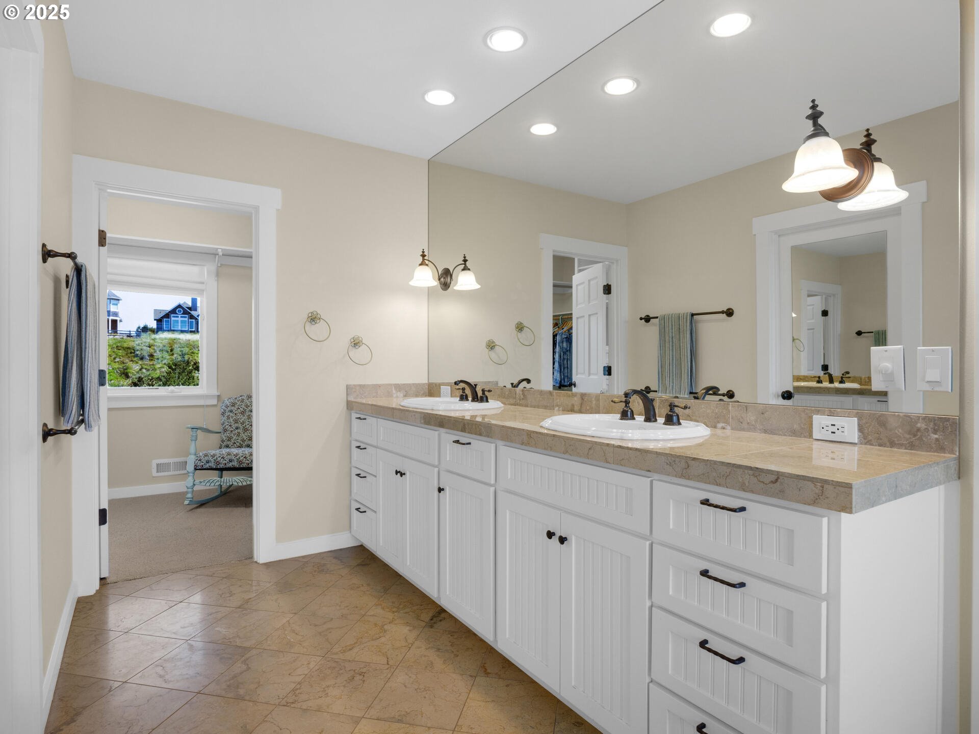 89185 Pinehurst Road Seaside, OR 97138 - Photo 20 of 48 a spacious bathroom with a granite countertop sink a mirror and a toilet