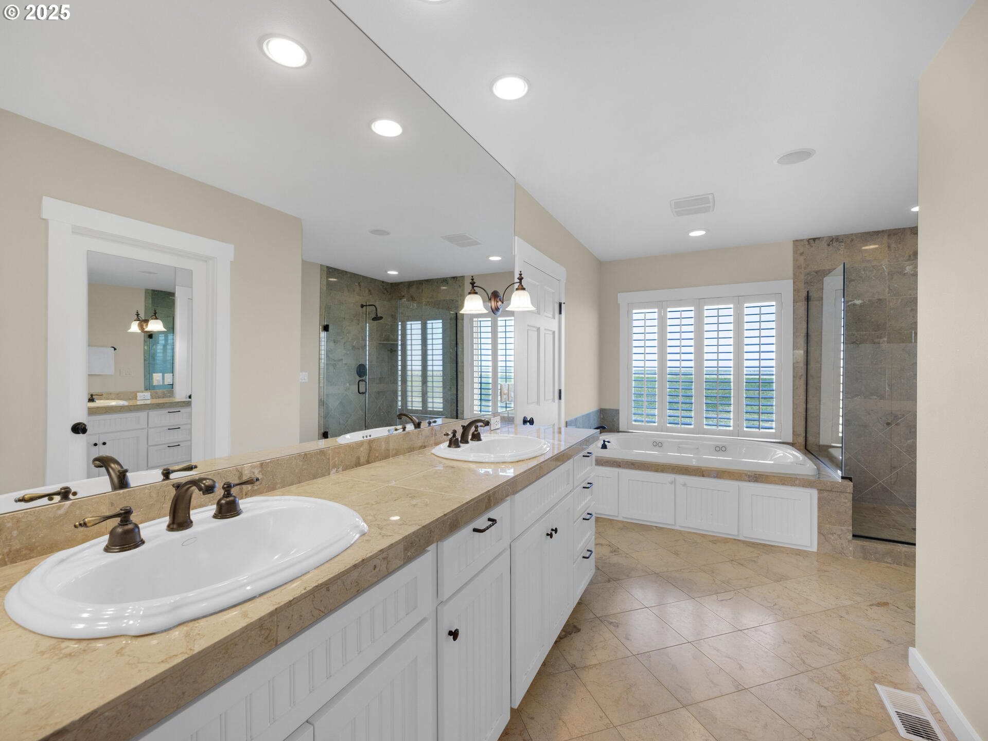89185 Pinehurst Road Seaside, OR 97138 - Photo 21 of 48 a bathroom with a sink tub double vanity and mirror