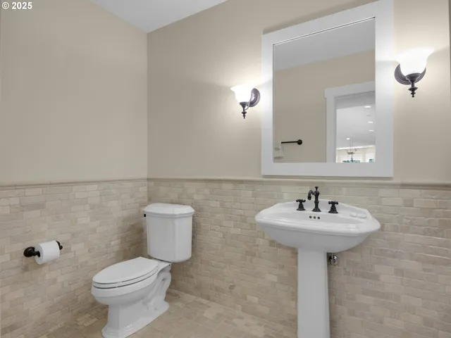 a bathroom with a sink toilet and mirror