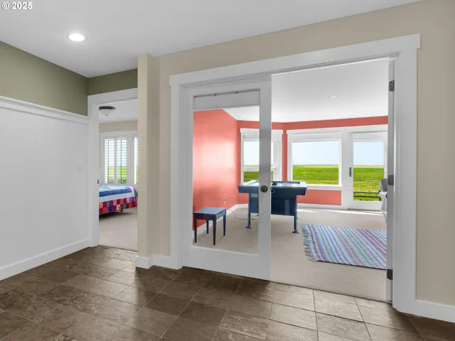 a living room with furniture and large windows