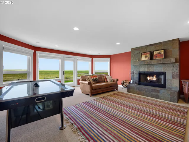 a living room with furniture a large window and a fireplace