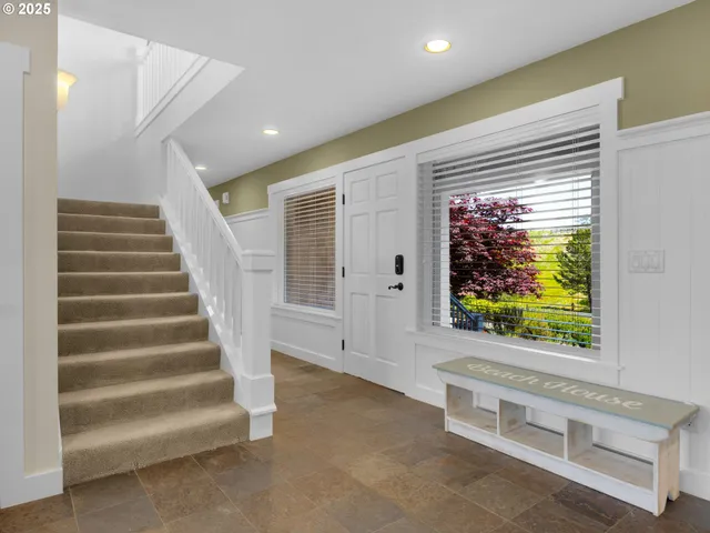 a view of entryway with wooden floor and a front door