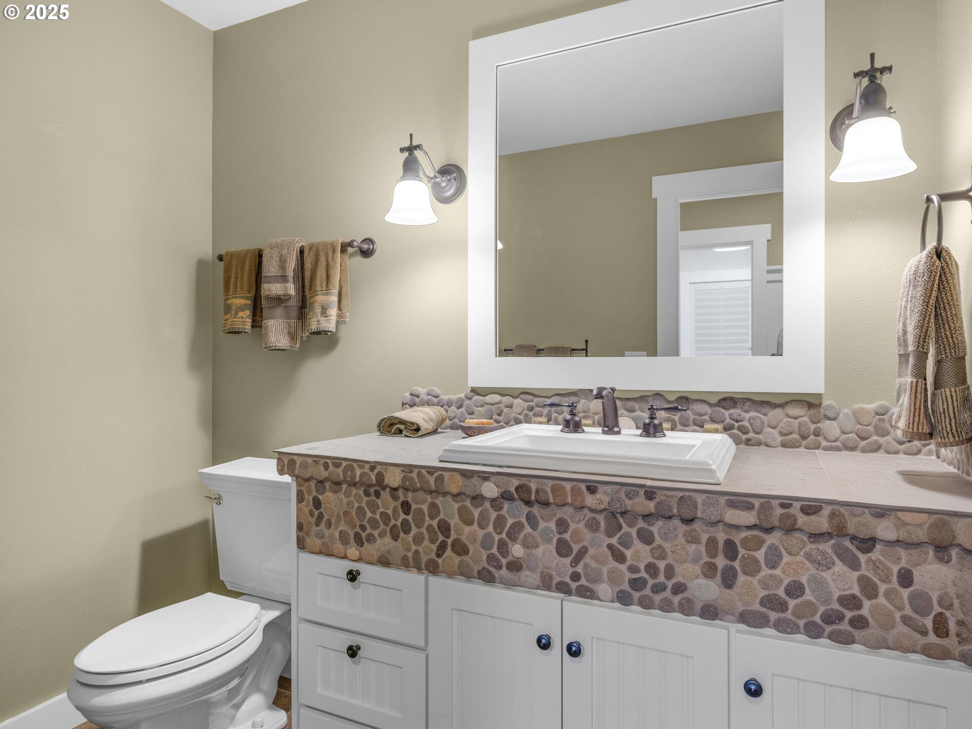 89185 Pinehurst Road Seaside, OR 97138 - Photo 28 of 48 a bathroom with a granite countertop toilet sink and mirror