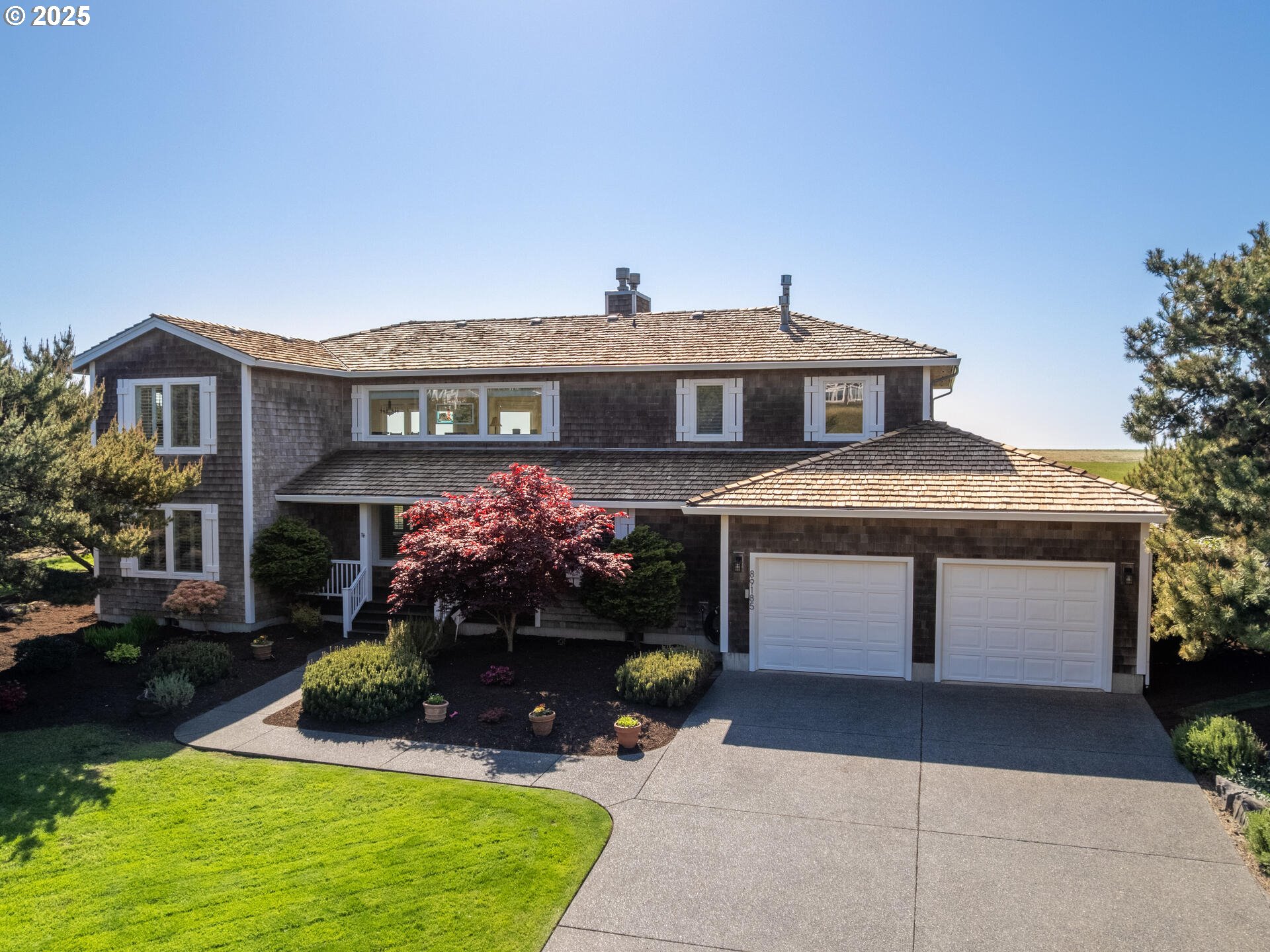 89185 Pinehurst Road Seaside, OR 97138 - Photo 3 of 48 a front view of a house with a yard and garage