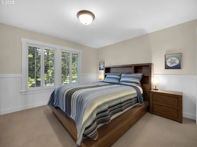 a bed sitting in a bedroom next to a window