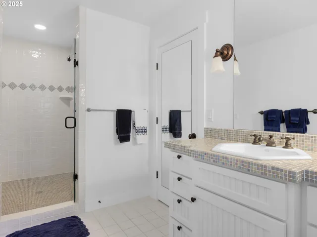 a bathroom with a shower sink and mirror