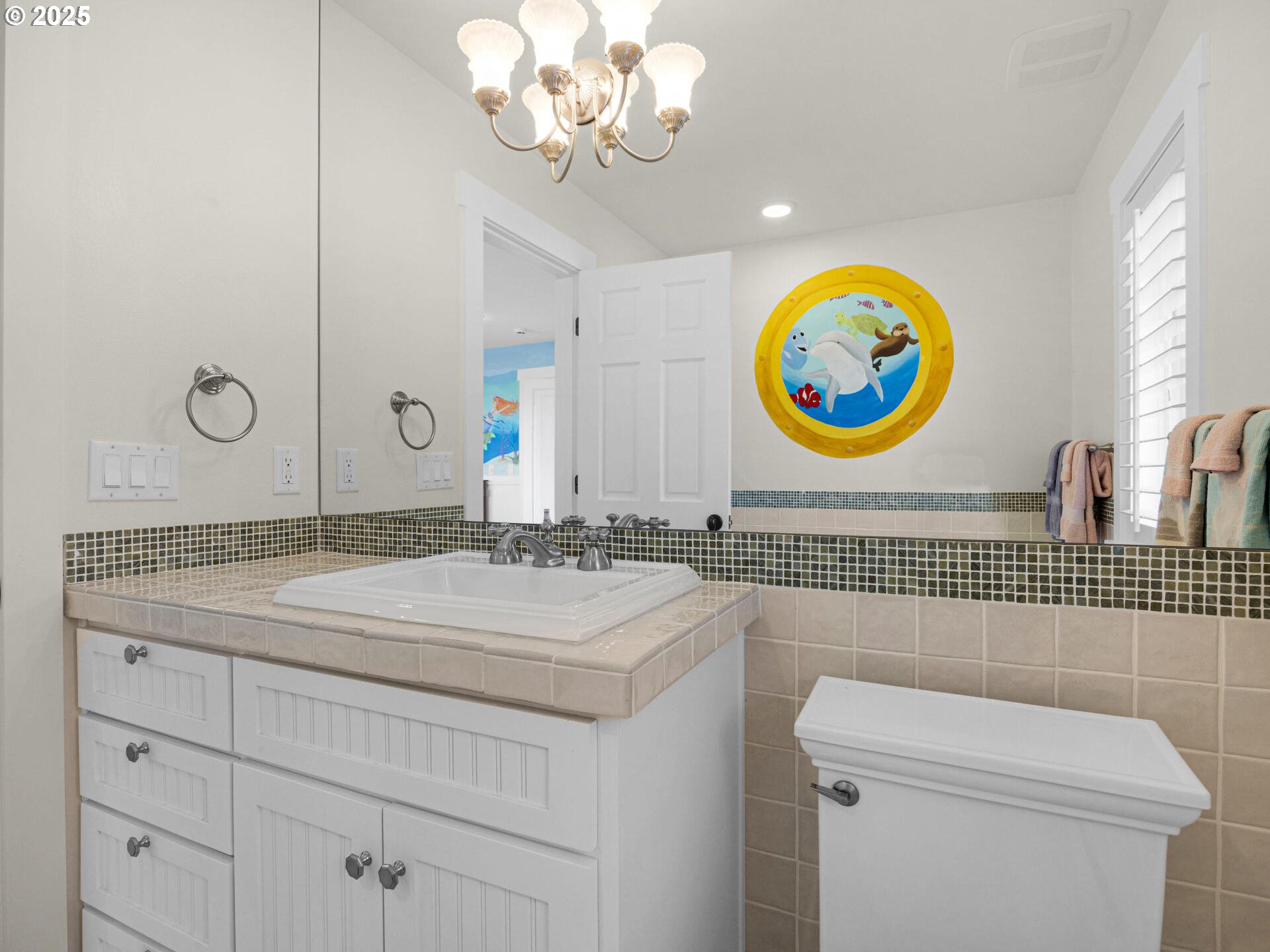 89185 Pinehurst Road Seaside, OR 97138 - Photo 35 of 48 a bathroom with a sink a mirror and a toilet