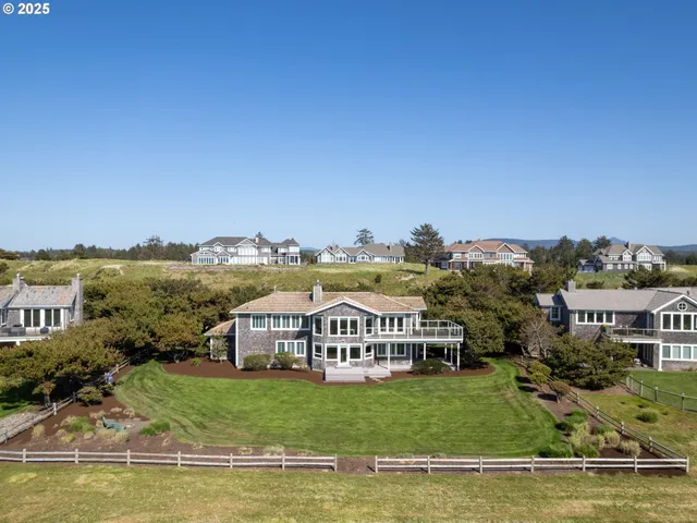 a view of a house with pool and a big yard