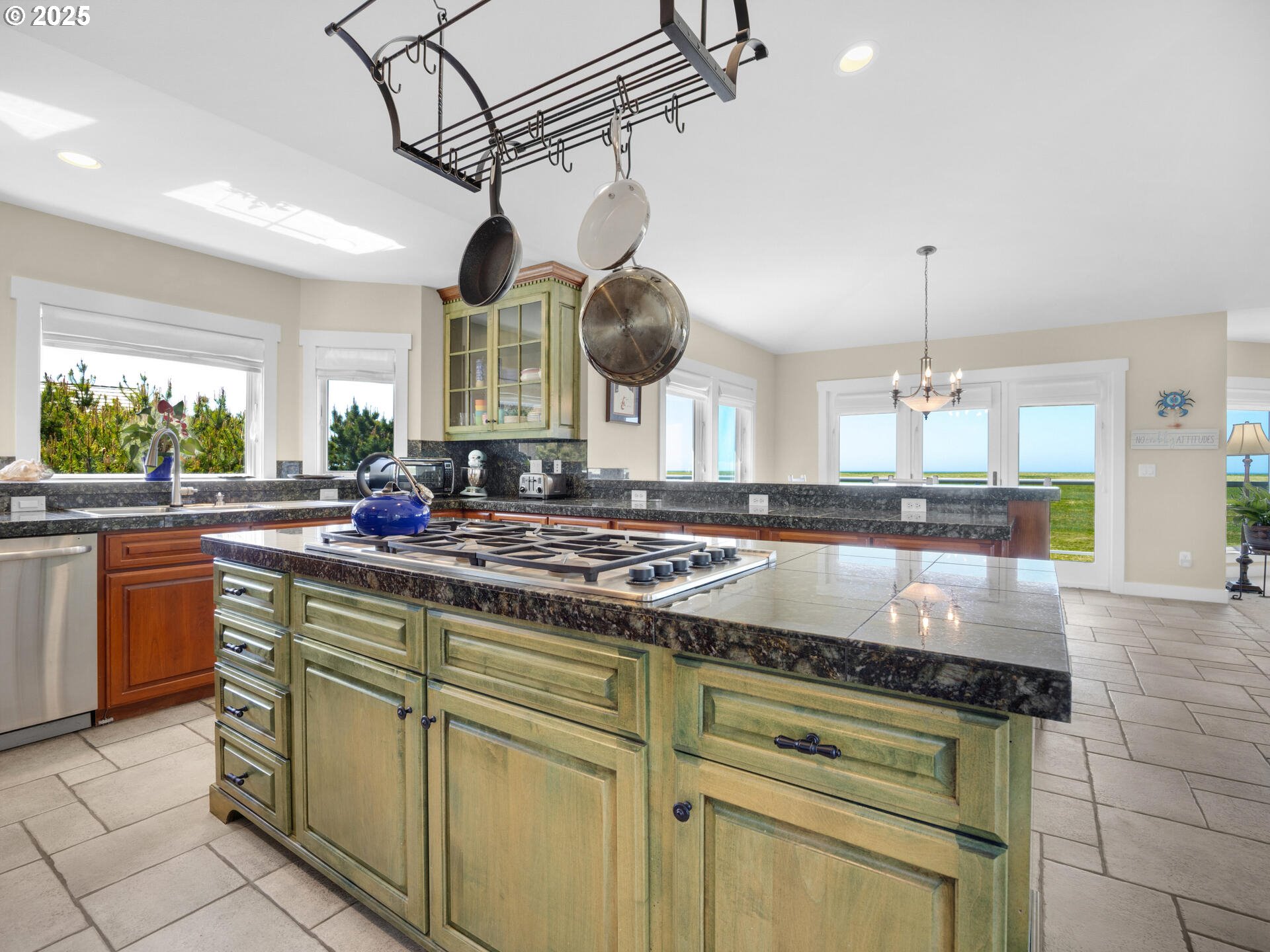 89185 Pinehurst Road Seaside, OR 97138 - Photo 9 of 48 a kitchen with stainless steel appliances granite countertop a sink a stove and cabinets