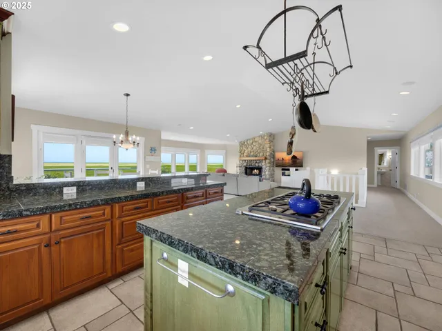 a kitchen with stainless steel appliances granite countertop a sink a counter space and cabinets