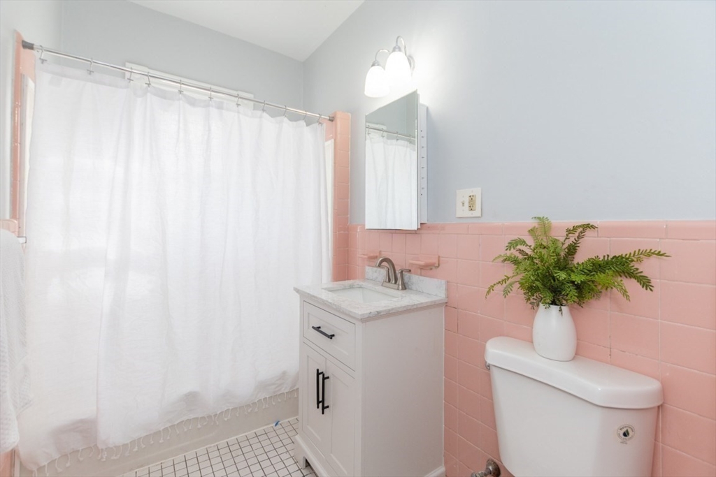 29 Mt Ida Road Boston, MA 02122 - Photo 14 of 22 a bathroom with a sink a toilet and a mirror
