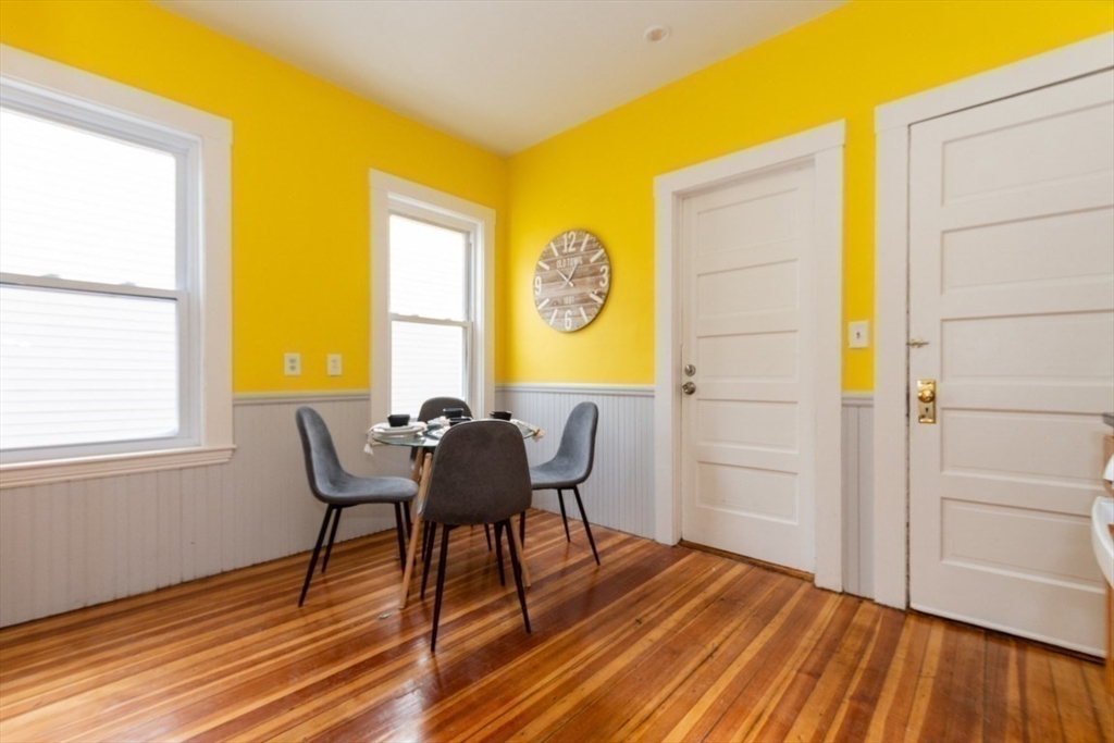 29 Mt Ida Road Boston, MA 02122 - Photo 10 of 22 a view of a dining room with furniture and wooden floor