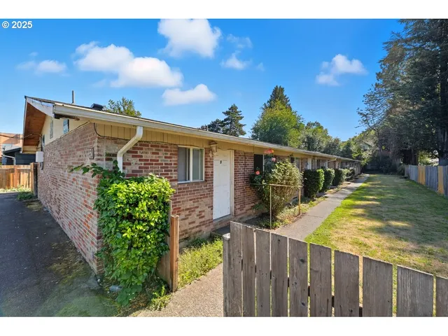 a view of a house with wooden fence