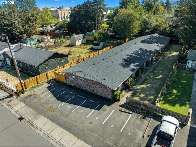 an aerial view of residential houses with outdoor space