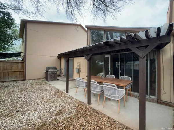 a patio with a table and chairs