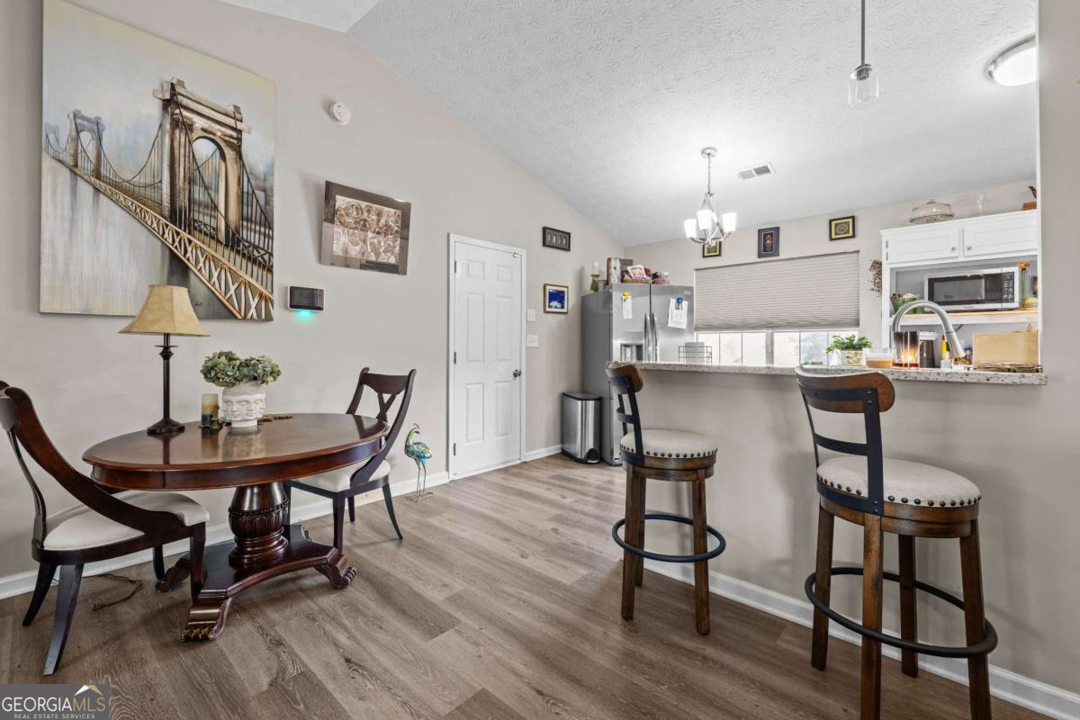 6324 Amberly Road Rex, GA 30273 - Photo 11 of 22 a view of a dining room with furniture and wooden floor
