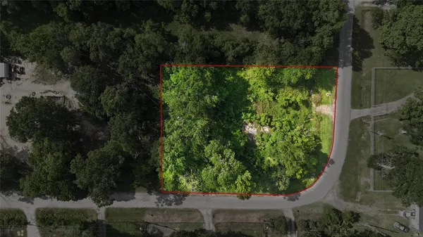 an aerial view of residential house with outdoor space and trees