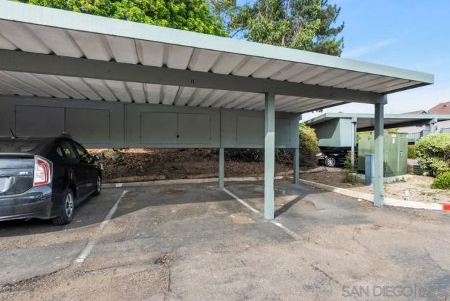 a view of a patio with table and chairs under an umbrella
