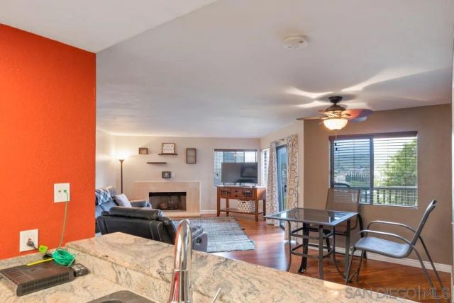 a living room with furniture a fireplace and a table