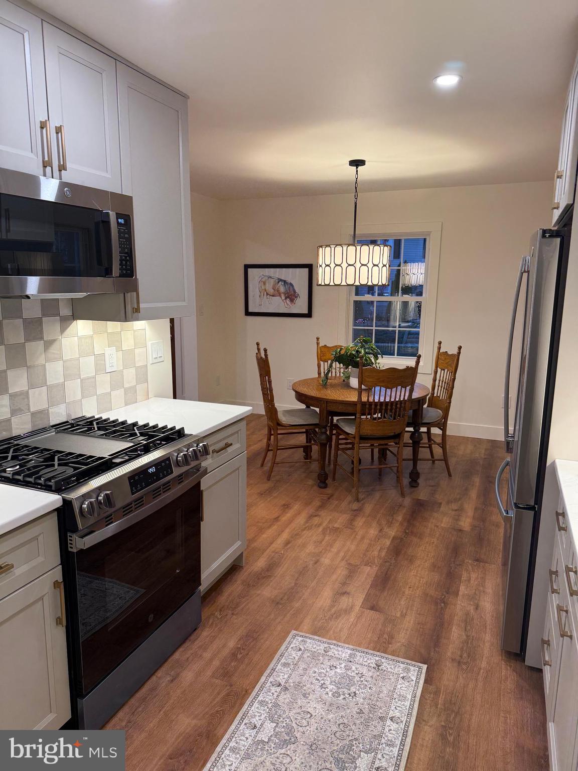 202 Chestnut Street Brooklawn, NJ 08030 - Photo 11 of 29 a kitchen with a stove a sink and a refrigerator