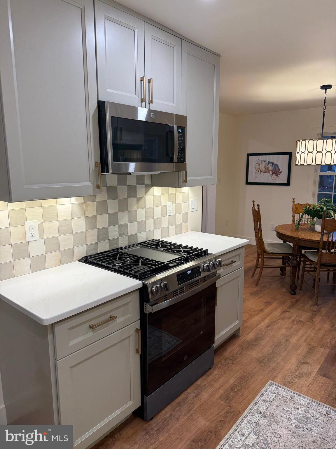 202 Chestnut Street Brooklawn, NJ 08030 - Photo 12 of 29 a kitchen with stainless steel appliances a sink a stove a microwave and cabinets