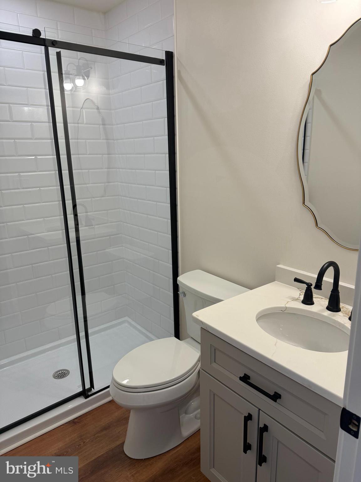 202 Chestnut Street Brooklawn, NJ 08030 - Photo 13 of 29 a bathroom with a sink a toilet a mirror and shower