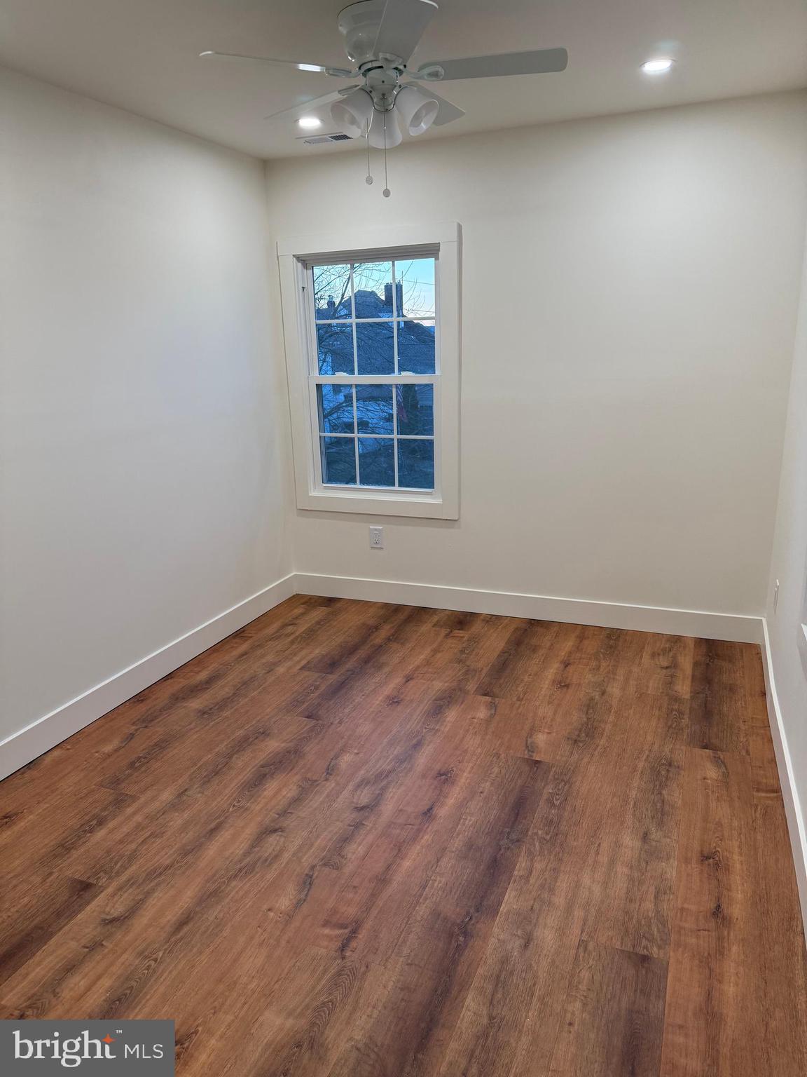 202 Chestnut Street Brooklawn, NJ 08030 - Photo 19 of 29 an empty room with wooden floor and windows