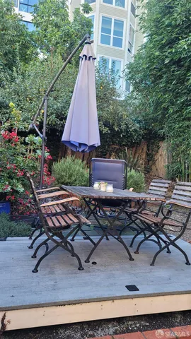 a small view of a backyard with plants and a patio