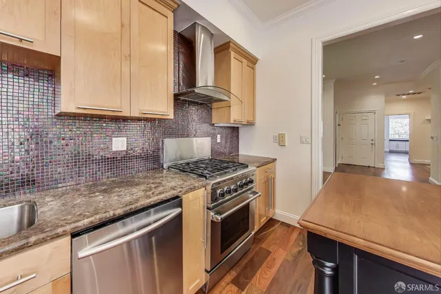 a kitchen with stainless steel appliances granite countertop a stove a sink and a granite counter tops
