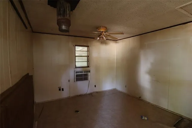 a view of a room with window and a ceiling fan