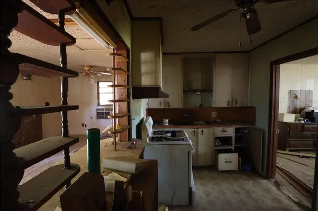 a kitchen with table chairs stainless steel appliances and cabinets