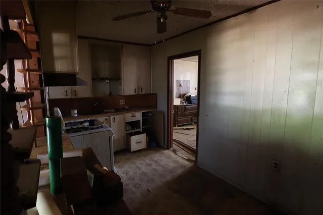 a kitchen with a refrigerator and a stove top oven