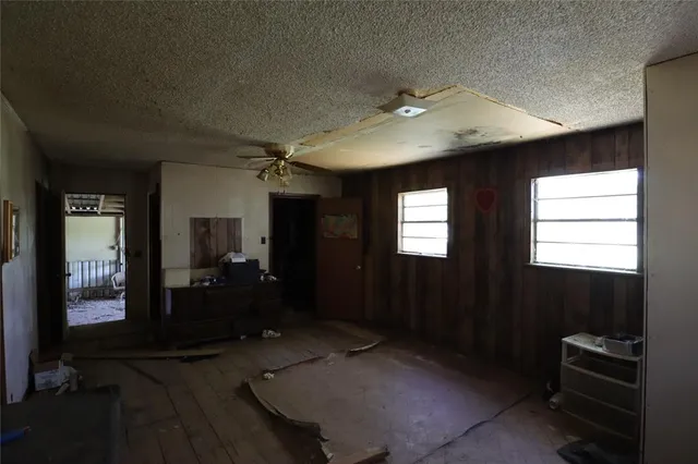 a living room with furniture and a ceiling fan