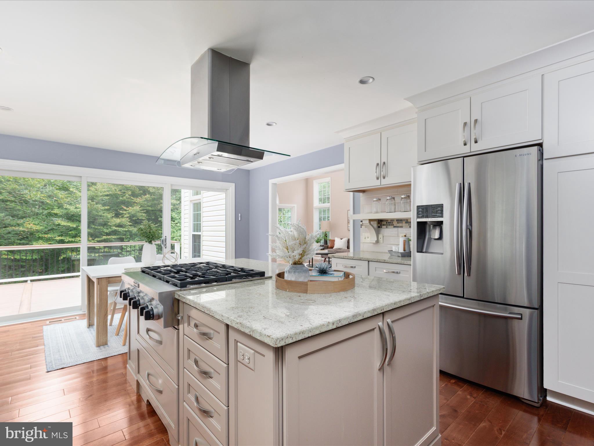 20462 Quarterpath Trace Circle Sterling, VA 20165 - Photo 14 of 58 a kitchen with stainless steel appliances granite countertop a stove and a refrigerator