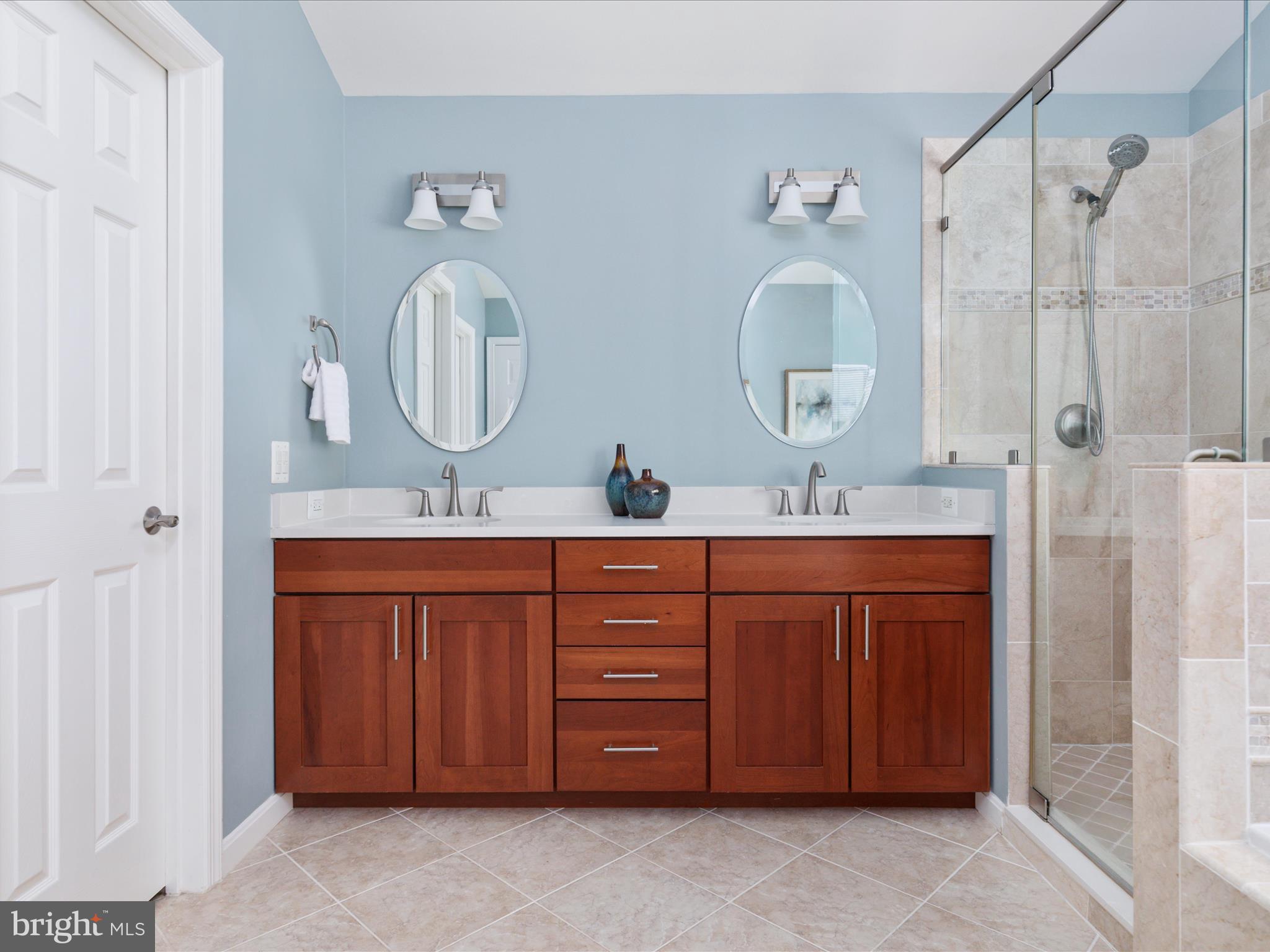 20462 Quarterpath Trace Circle Sterling, VA 20165 - Photo 30 of 58 a bathroom with a double vanity sink and a mirror