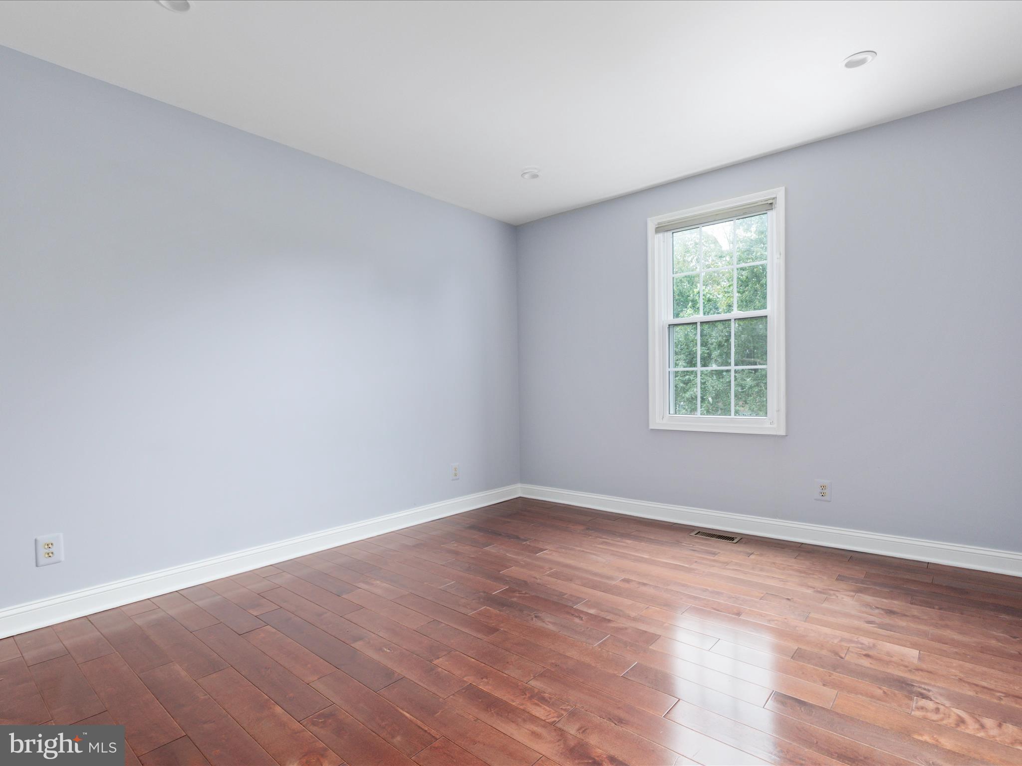 20462 Quarterpath Trace Circle Sterling, VA 20165 - Photo 32 of 58 an empty room with wooden floor and windows